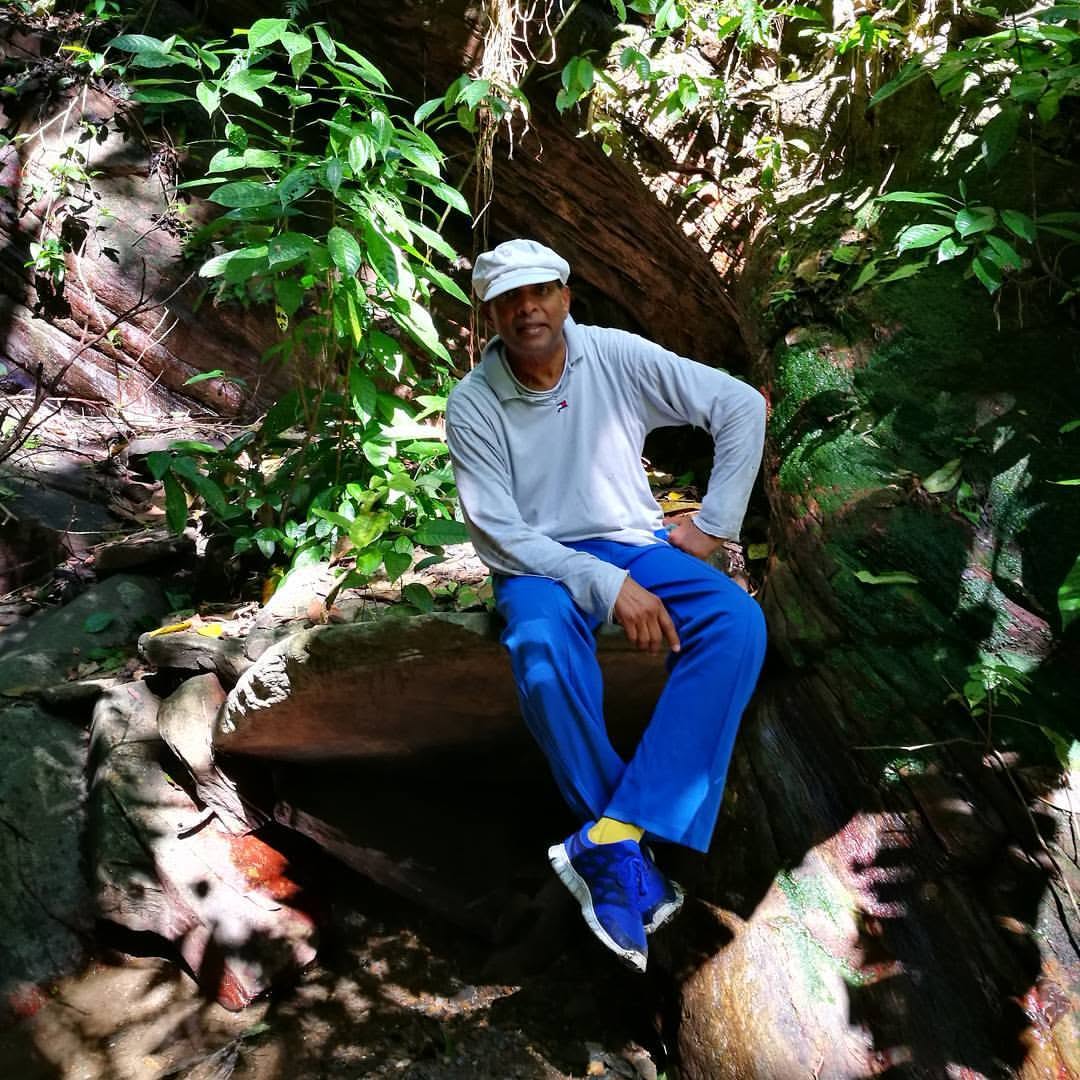 Seeram Ken Maharaj outdoors among tropical vegetation