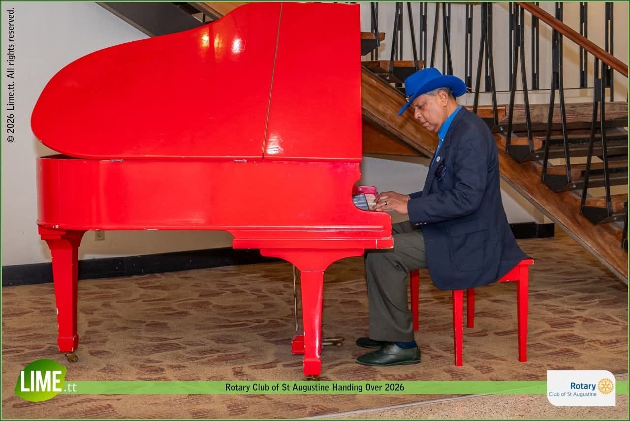 Seeram Ken Maharaj playing a red grand piano