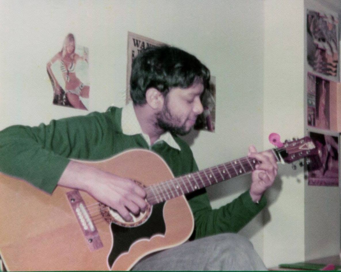 A younger Seeram Ken Maharaj playing guitar